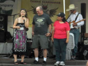 Washougal: Country crooner Carrie Cunningham passes along a donation to Rick Cook and Elizabeth Francis of Clark County Special Olympics.