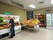 Vancouver Food Cooperative interim manager Shawn Morrill organizes the produce at the Main Street store on Oct. 11.