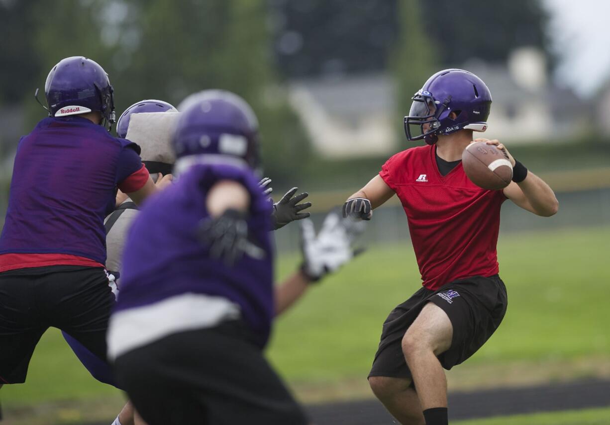 Heritage High School quarterback Loren Standiford throws during practice.