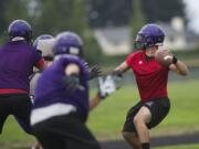 Heritage High School quarterback Loren Standiford throws during practice.