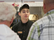 Lucas Schwartz, 17, takes customers' orders at Burgerville in Vancouver.