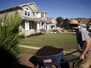 Workers landscape at a fevered pitch outside The Nantucket, built by Axiom Luxury Homes as a Parade of Homes entry.