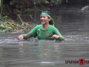 Mindy Schleif of Camas wades through water in the Spartan Race in December in Malibu, Calif.