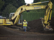 Heavy equipment operator Mark Hammond breaks for lunch Friday at the site of Crestline Elementary School, which burned Feb.