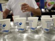 A fairgoer grabs ice water courtesy of Clark Public Utilities at the Clark County Fair on Monday.