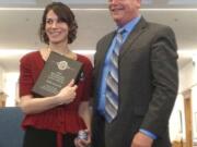 Chief of Staff Ken Kanikeberg of the Office of the Superintendent of Public Instruction stands with Anne Galvas,  an employee of Vancouver Public Schools, after she received her award as state classified employee of the year in Olympia Friday.