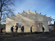 Volunteers help rebuild John Matson's barn on Saturday, which burned down earlier this year.