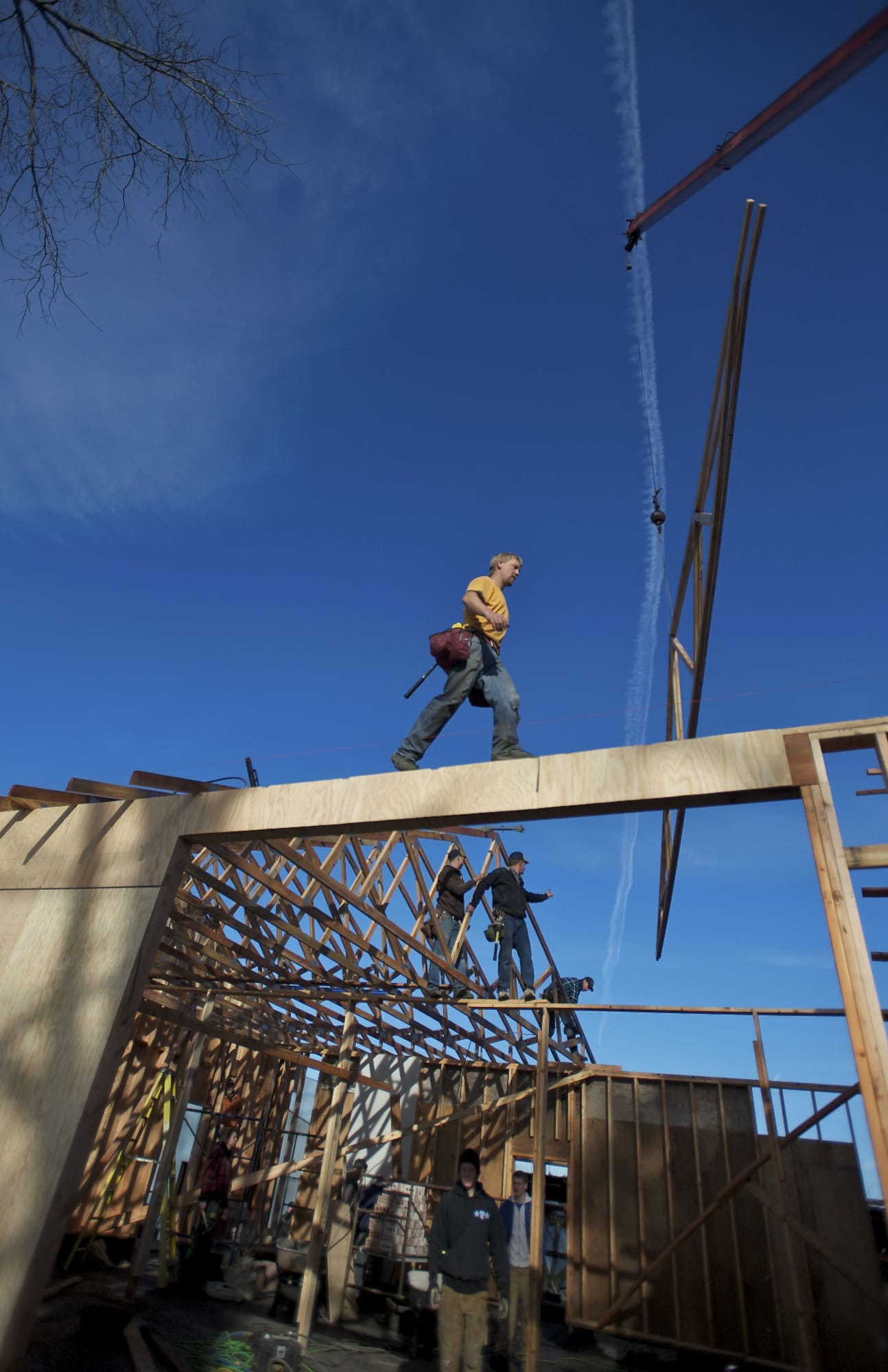 Vernon Matson, top center, son of John Matson, came from Idaho to help rebuild his father's barn with other volunteers, on Saturday, which burned down earlier this year.