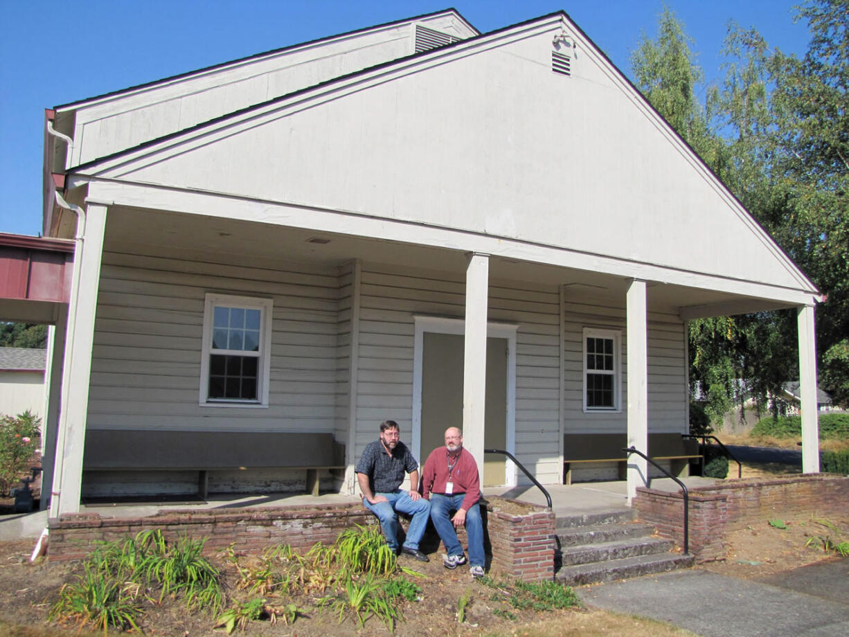 Jeff Davis, left, and Jim Wulf sit in front of a World War II Army chapel, now part of the Memorial Lutheran Church campus. First lady Eleanor Roosevelt wanted chapels -- not theaters or assembly halls -- for religious services on U.S.