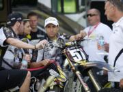 Mike Alessi, center, talks with teammate Jake Canada, left, and team owner Mike Genova prior to Thursday's practice session at Washougal MX Park.