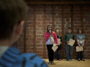 Kailie Morrill recites her haiku, &quot;Cake,&quot; while fellow Image Elementary School third-graders wait their turn Sunday. They are from left, Casey Logan, Preston Pickrell and Katelyn McCuistion.