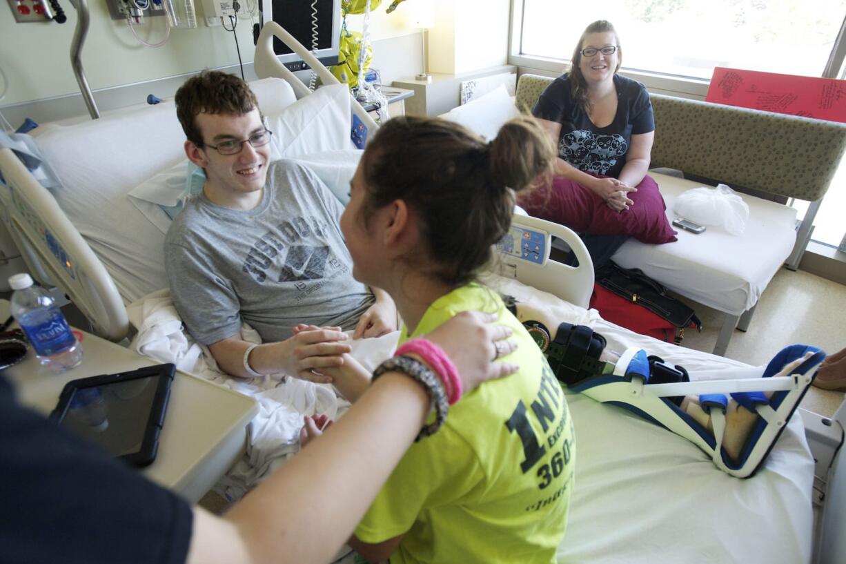 For the past weeks that he's been in the hospital, Justin Carey, 16, center, has gotten support from his girlfriend Lexi Davisson, 14, his sister Jaden Carey, 13, far left, and his mom Janette Chumley.