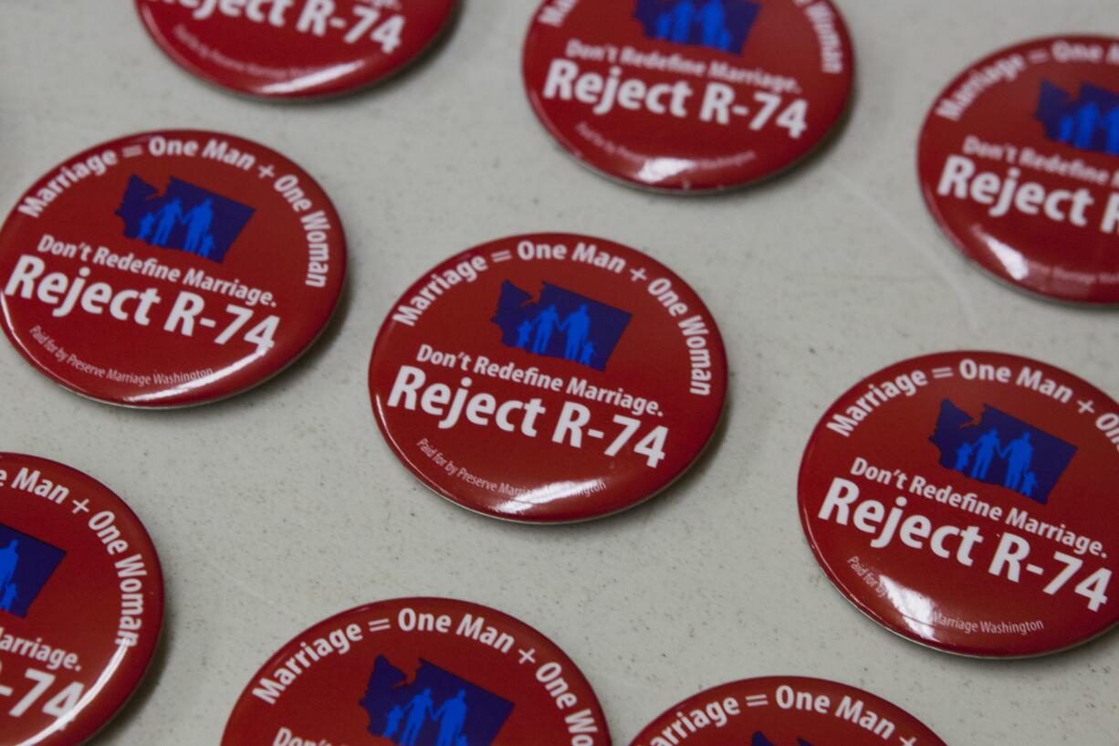 State and Clark County opponents of same-sex marriage provided the public with buttons, signs and other campaign material during a rally earlier this month in Vancouver.