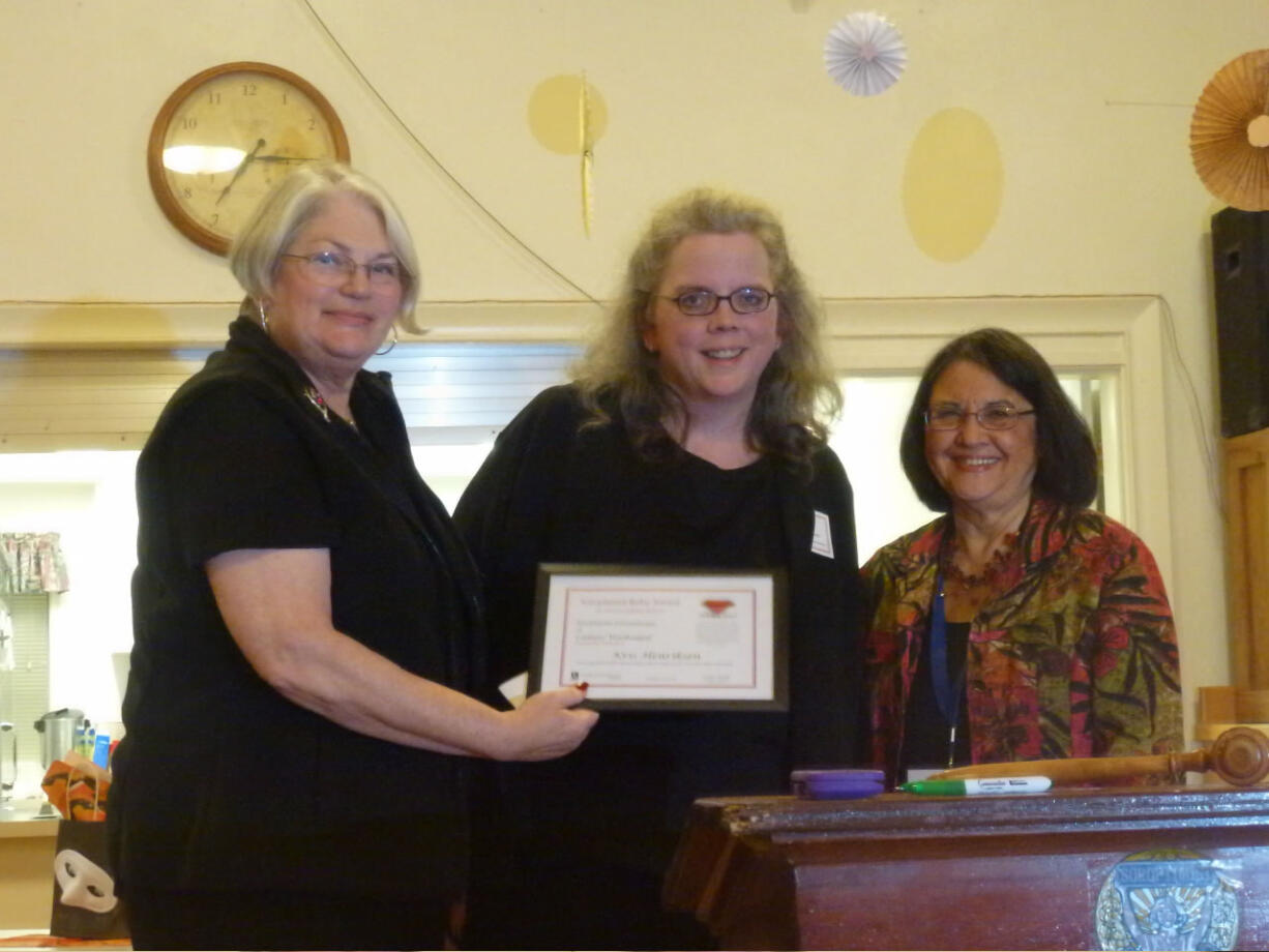 Camas: Award winner Kris Henriksen, center, is flanked by Soroptimist International Camas/Washougal officials Janis Rink, left, and Jan Alberg.