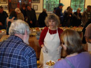 Venersborg: Sara Cooper serves up apple slices at the Sixth Annual Heirloom Apple Fest.