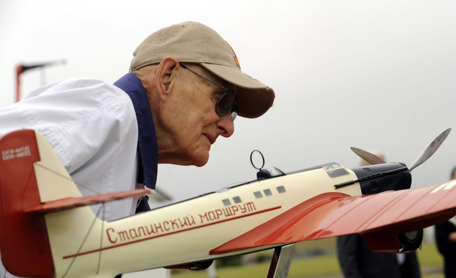 Evan Petcoff, who was at Pearson Field on the day of the Chkalov landing in 1937, examines the ANT-25 model on display just prior to Wednesday's 75th anniversary observance.