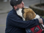 Desert Storm veteran Shawn Brooks, of Molalla, Ore., hugs his dog Bella before they test for a service-dog certification at Man's Best Friend kennel in Battle Ground.