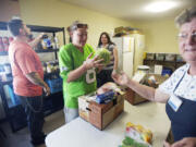 Heather Johnson, 23, of Vancouver picks up groceries at the River of Life Foursquare Church food bank on a Wednesday afternoon in June.