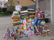 Felida: Fourth-grader Jared Wallingford and sixth-grader Alicia Wallingford show off pet food in April, which they helped gather during their recent donation drive.