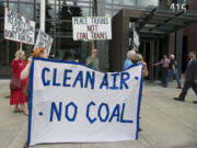 Members of anti-coal group Beyond Coal greet Vancouver Mayor Tim Leavitt, holding the door, and Councilor Bart Hansen, far right, as they enter City Hall on July 2.