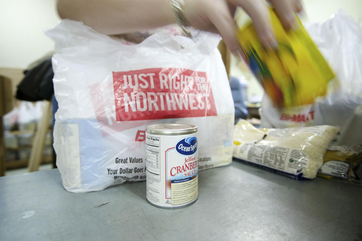 Volunteer Rebekah Papka fills a bag with food.