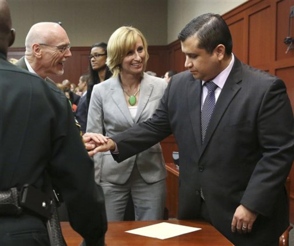 George Zimmerman, right, is congratulated by his defense team after being found not guilty.