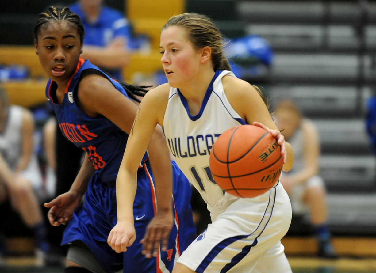 La Center player Bethany Whitten is pursued by Benson's Janae Brown (L) at a girls basketball game at Evergreen High School in Vancouver Monday December 28, 2015.