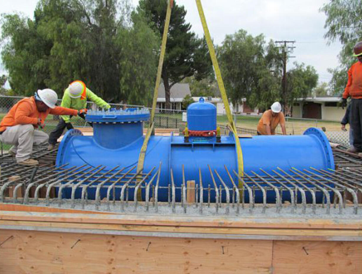 Workers prepare to make the first commercial installation of an in-pipe hydropower system in Riverside, Calif.