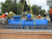 Workers prepare to make the first commercial installation of an in-pipe hydropower system in Riverside, Calif.