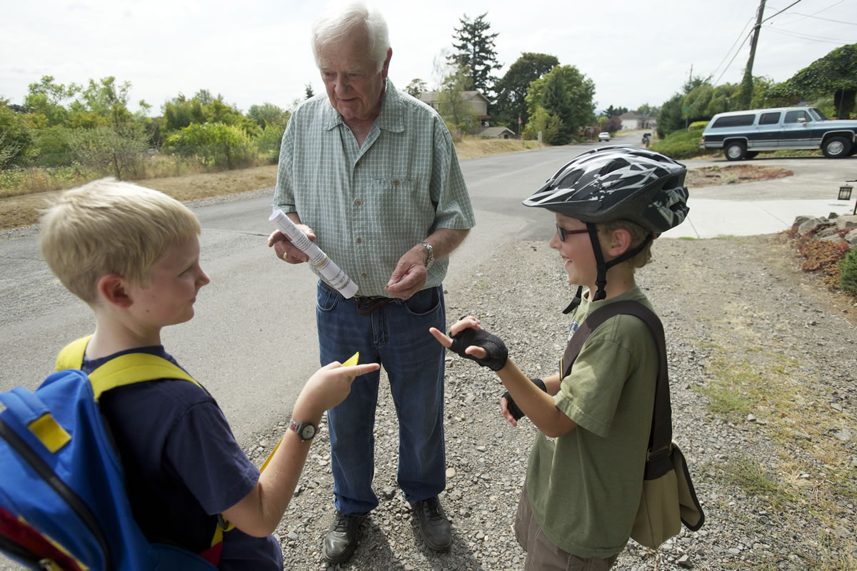 Southeast Middle Way resident Bert Sewall, 83, forks over a quarter for the latest edition of The Weekly Neighbor.