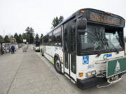 Passangers wait to board a C-Tran bus April 20 at the Vancouver Mall Transit Center.