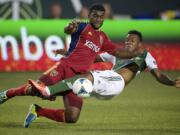 Brandon McDonald, left, of Real Salt Lake, battles Rodney Wallace of the Portland Timbers for control of the ball. Wallace scored a goal in the first half.