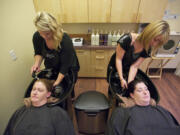 Second Step Housing clients, from lower left, Charlene Burrell, 39, and Jennifer Pierce, 31, won a haircut and color by stylists, from upper left, Emily Yaden and Sara Biaggi at Salon Magnolia in Camas.