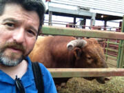 Zachary Kaufman and rodeo bull Red Robin in a calm moment.