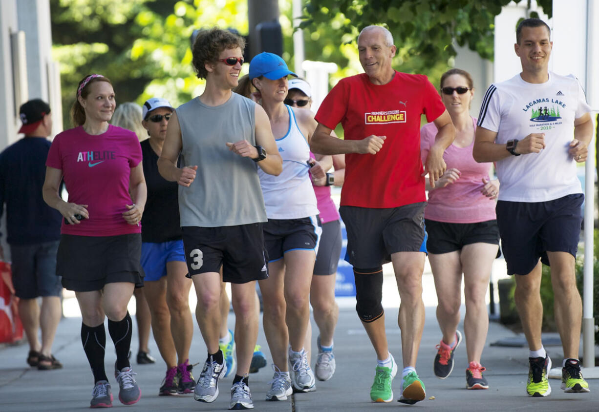 Bart Yasso, red shirt, Runners World running guru and a presenter at the sports expo at the Hilton, leads a short trainning run, Friday, June 15, 2012.