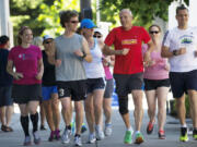 Bart Yasso, red shirt, Runners World running guru and a presenter at the sports expo at the Hilton, leads a short trainning run, Friday, June 15, 2012.