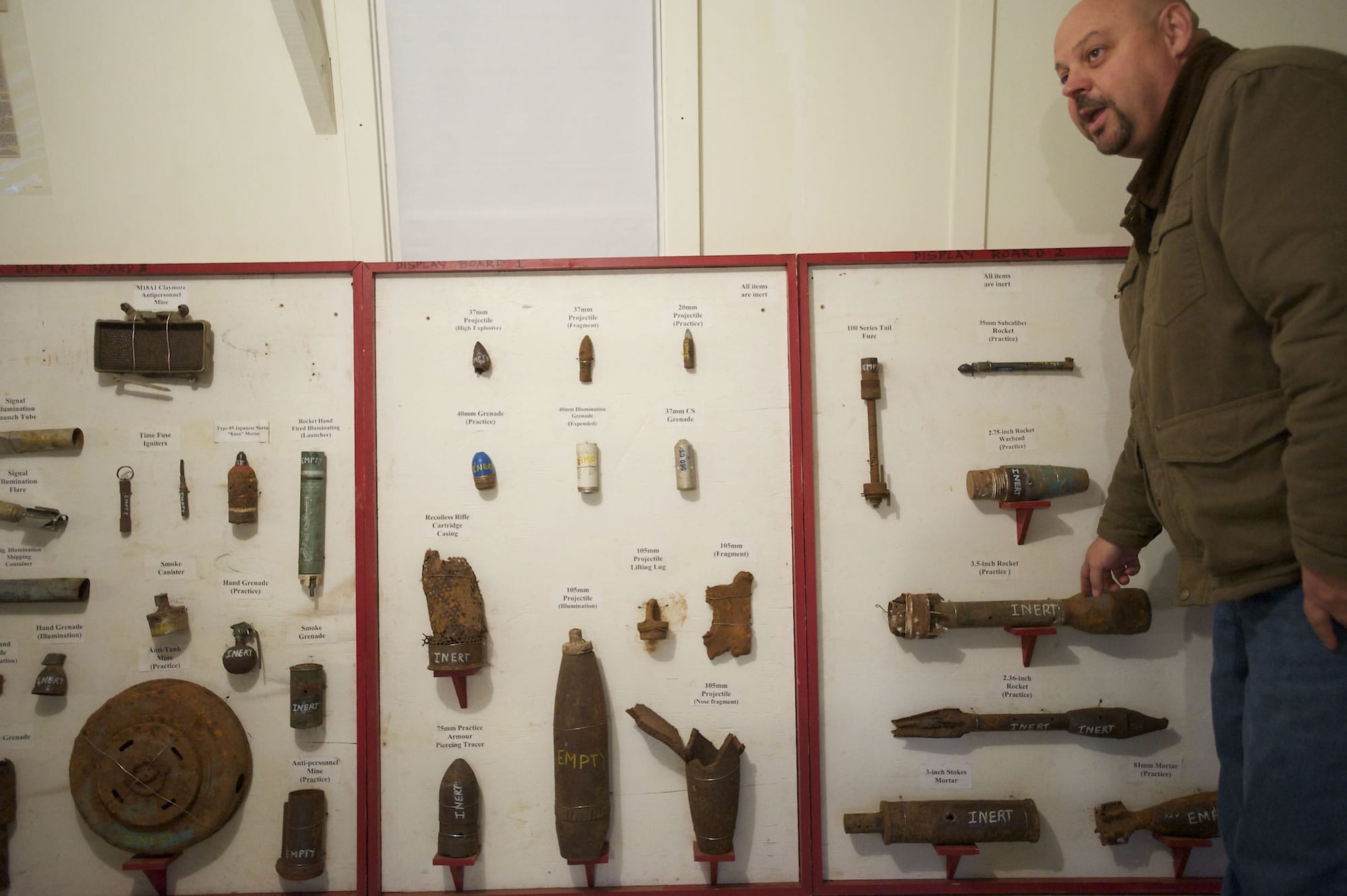 Greg Johnson, Clark County munitions safety adviser, points Friday to a munitions board displaying the dangerous ordinance that is being found at Camp Bonneville.