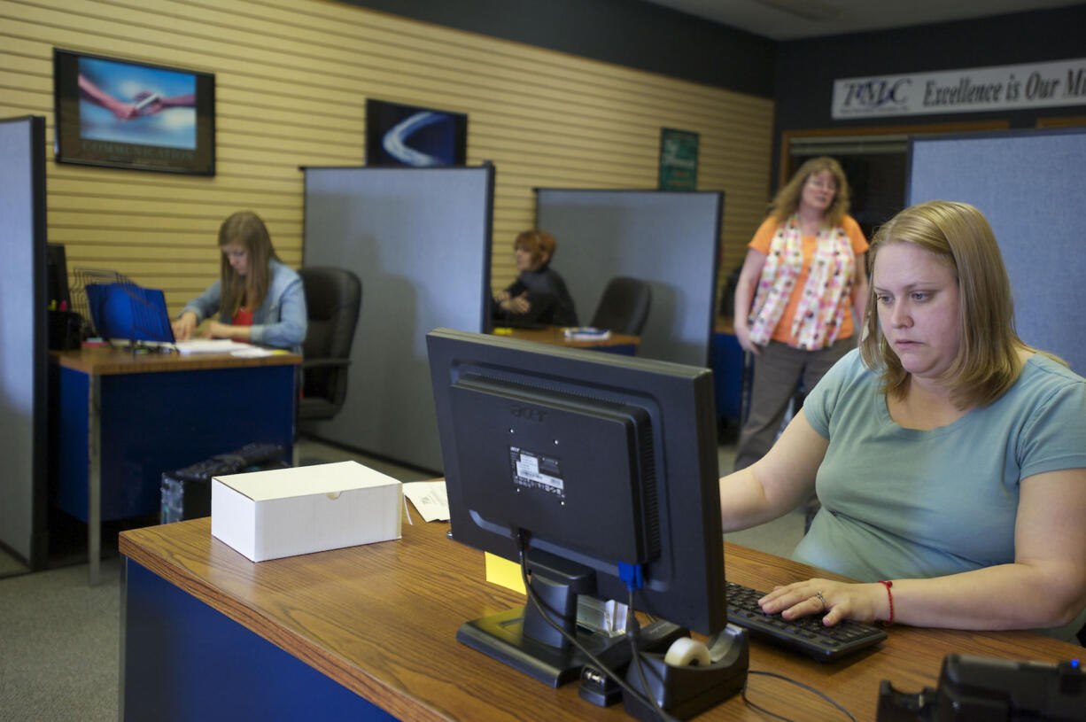 Christina Suarez works at her desk at Total Merchant Concepts.