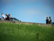 Law enforcement officers take two men in to custody on the southbound shoulder of Interstate 5 just north of the 78th Street exit, after they allegedly robbed the IQ Credit Union on 13505 NE 10th Avenue in Salmon Creek on Thursday.