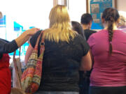 Salmon Creek: Assistance League of Southwest Washington members in red aprons, Ann McEnemy-Ogle, left, and Nancy Gaston, help foster teens find clothing at the leagueis annual back-to-school clothing event.