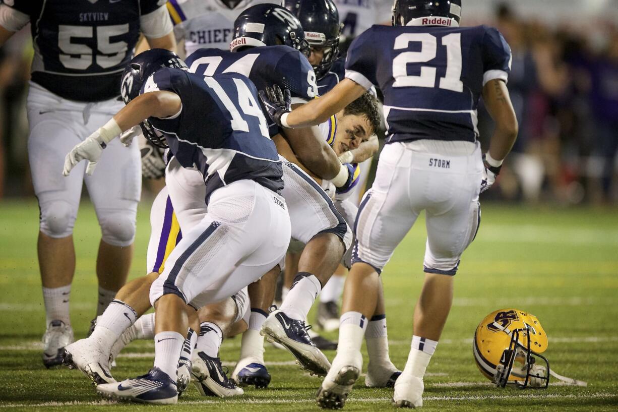 CLAYTON FRANK, 9, OF COLUMBIA RIVER HIGH SCHOOL loses his helmet as he is tackled during a game against Skyview High School AT KIGGINS BOWL FRIDAY SEPTEMBER 7, 2012 IN VANCOUVER, WASHINGTON.