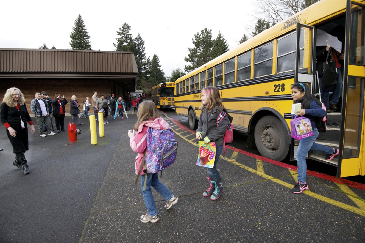 Ruth Beggs, left, welcomes third grade students from Crestline Elementary School to Riverview Elementary, which welcomed 93 Crestline third-graders, teachers and administrators after their school burned down.