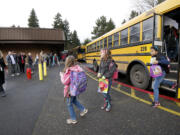 Ruth Beggs, left, welcomes third grade students from Crestline Elementary School to Riverview Elementary, which welcomed 93 Crestline third-graders, teachers and administrators after their school burned down.