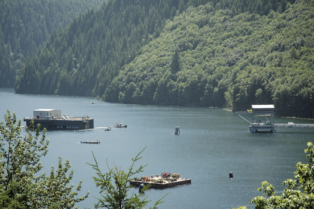 AlLEN Thomas/The Columbian
The Swift Reservoir floating fish collector, left, will be secured to the trestle on the right. Trucks to haul young salmon and steelhead downstream past the Swift, Yale and Merwin dams will reach the structure via the trestle.