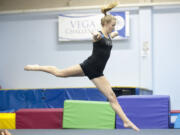 Caleigh Lofstead, fine tunes her floor routine as she practices gymnastics at the Vega Gym in Camas Wednesday December 23, 2015.