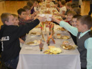 Washougal: Cape Horn-Skye Elementary School fifth-graders enjoy their feast to culminate their month-long Gratitude Challenge, in which they wrote holiday letters to troops, recognized important role models in their lives and kept a thankful journal.