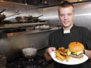 Austin Theroux displays a kangaroo burger in the kitchen at Bone's restaurant in Battle Ground.