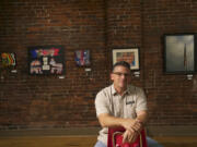 Daniel Wickwire talks about the art exhibit &quot;What is Democracy?&quot; at Gallery 360 on Sunday.