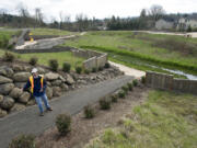 Cary Armstrong, Source Control Specialist with the Clark County Department of Environmental Services, shows a well maintained stormwater site in a Vancouver neighborhood in April 2011. The state's Department of Ecology is committed to working with Clark County on an alternative way for the county to meet clean-water standards, the department's new director, Maia Bellon, told state Rep.