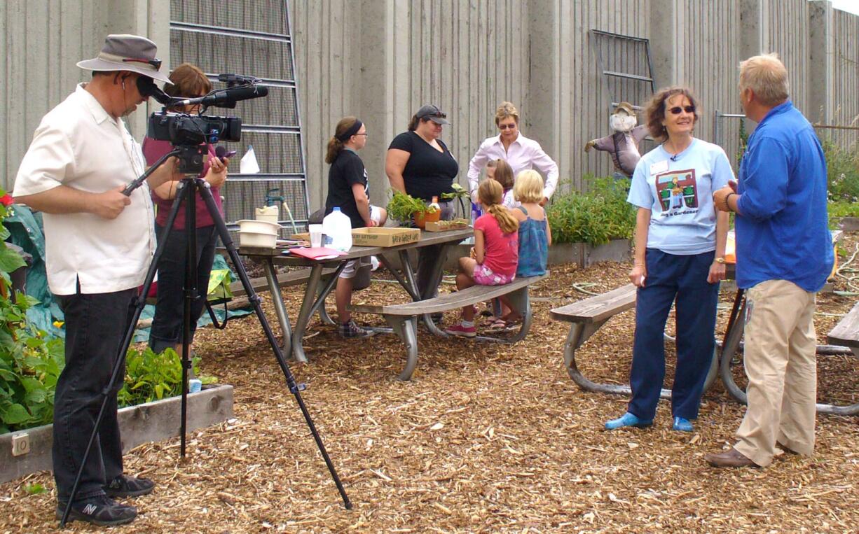 Hazel Dell: &quot;Garden Time TV's&quot; Jeff Gustin films William McClenathan interviewing Barbara Nordstrom at the Hazel Dell School and Community Garden for the Aug.